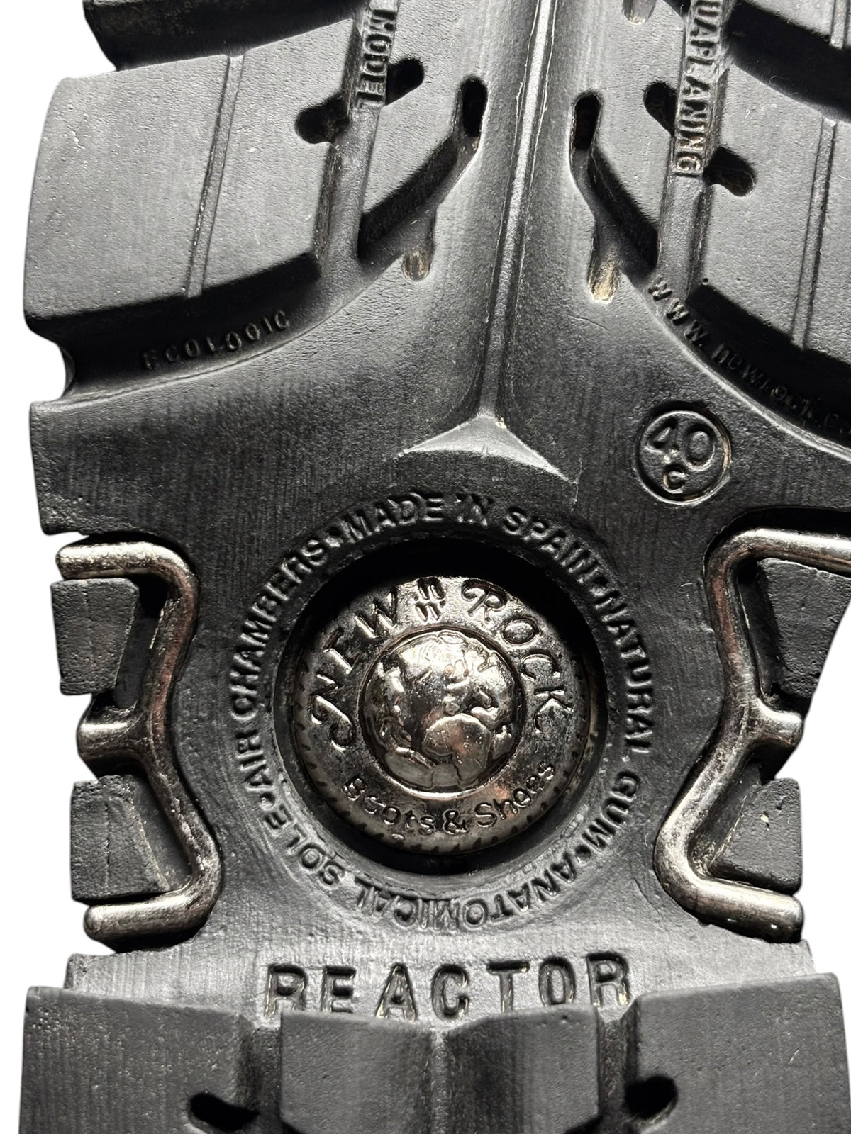 Knee-high boot sole with embossed “REACTOR” tread and metal eyelet detail
