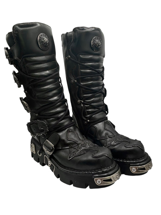 Black knee-high leather cross boots side-by-side with lace-up and metal buckles