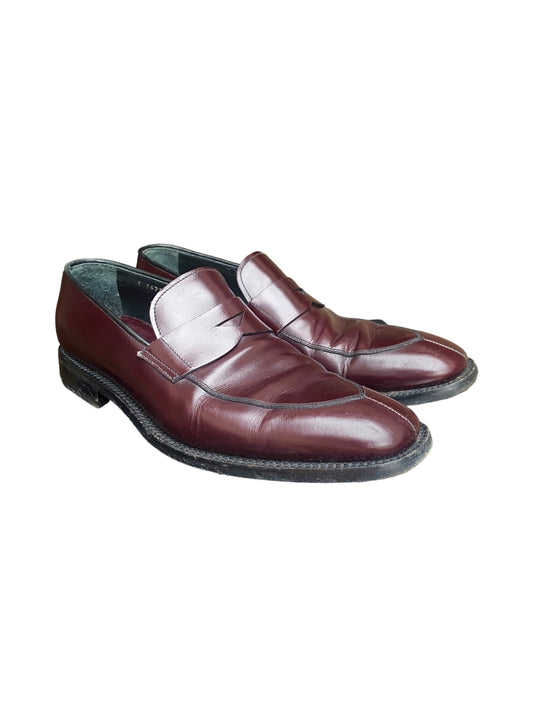 Burgundy leather slip-on loafers with dark rubber sole and stitched apron front