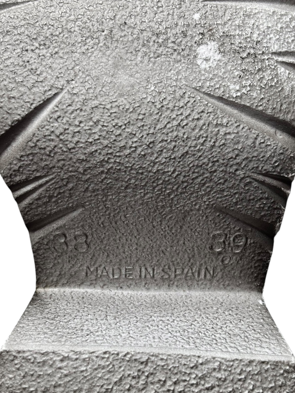 Platform sandal outsole close-up with embossed text and traction tread