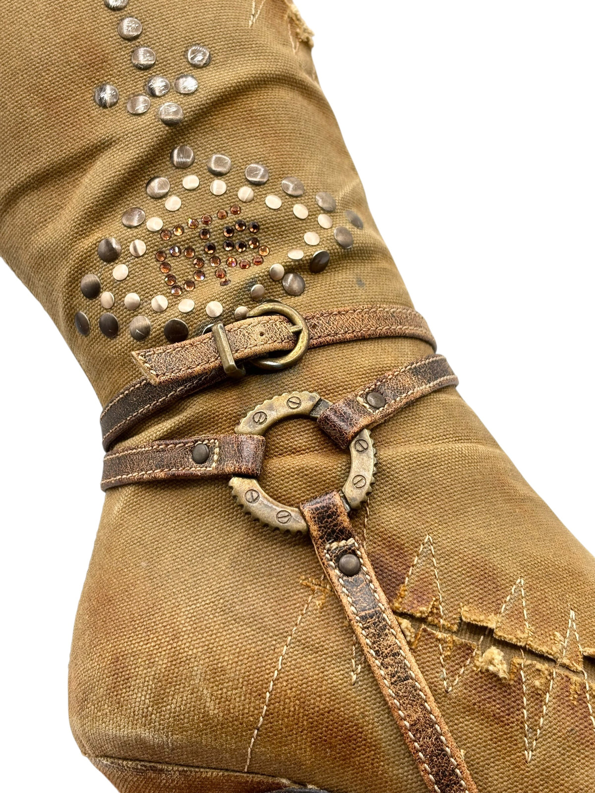 Close-up of tan boot ankle buckle strap with rhinestone detail