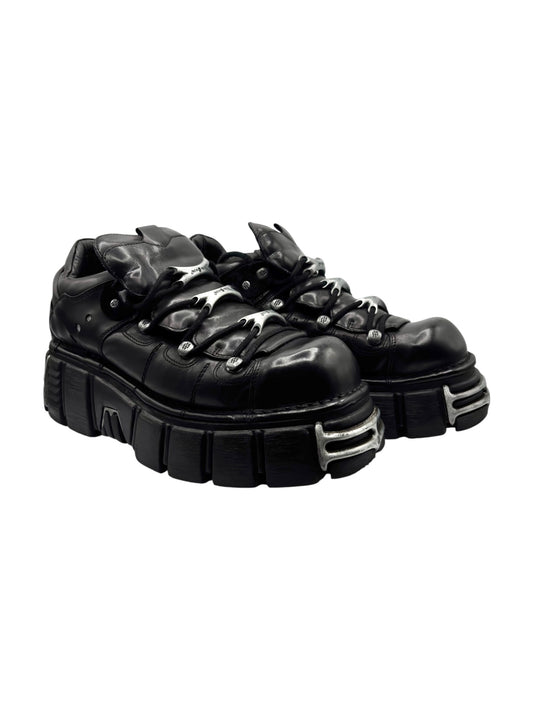 Black lace-up platform boots 3/4 view with oversized tread and eyelets