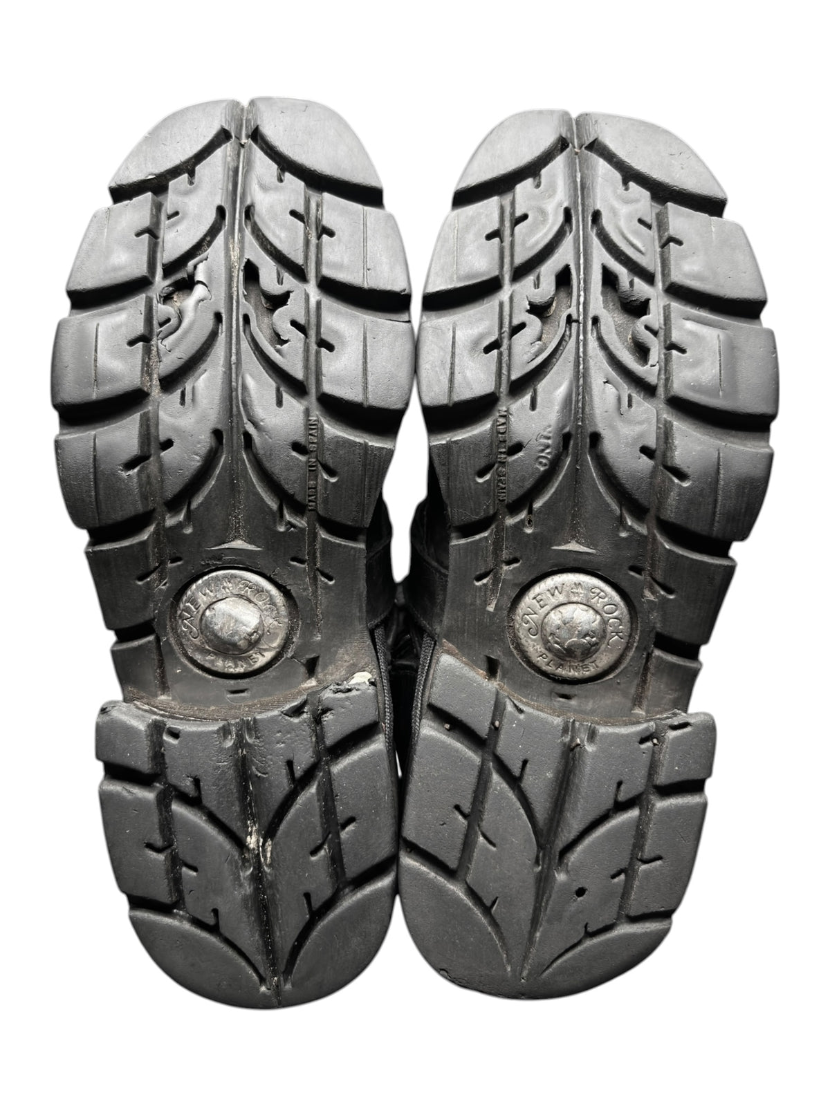 Pair of mid-calf leather boots with chunky tread soles, bottom view