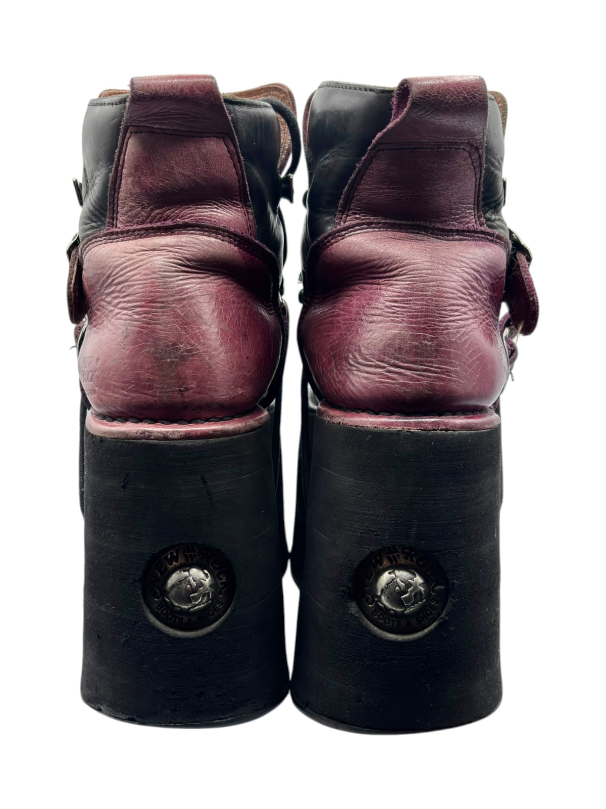 Pair of burgundy and black platform boots, rear view with embossed metal caps