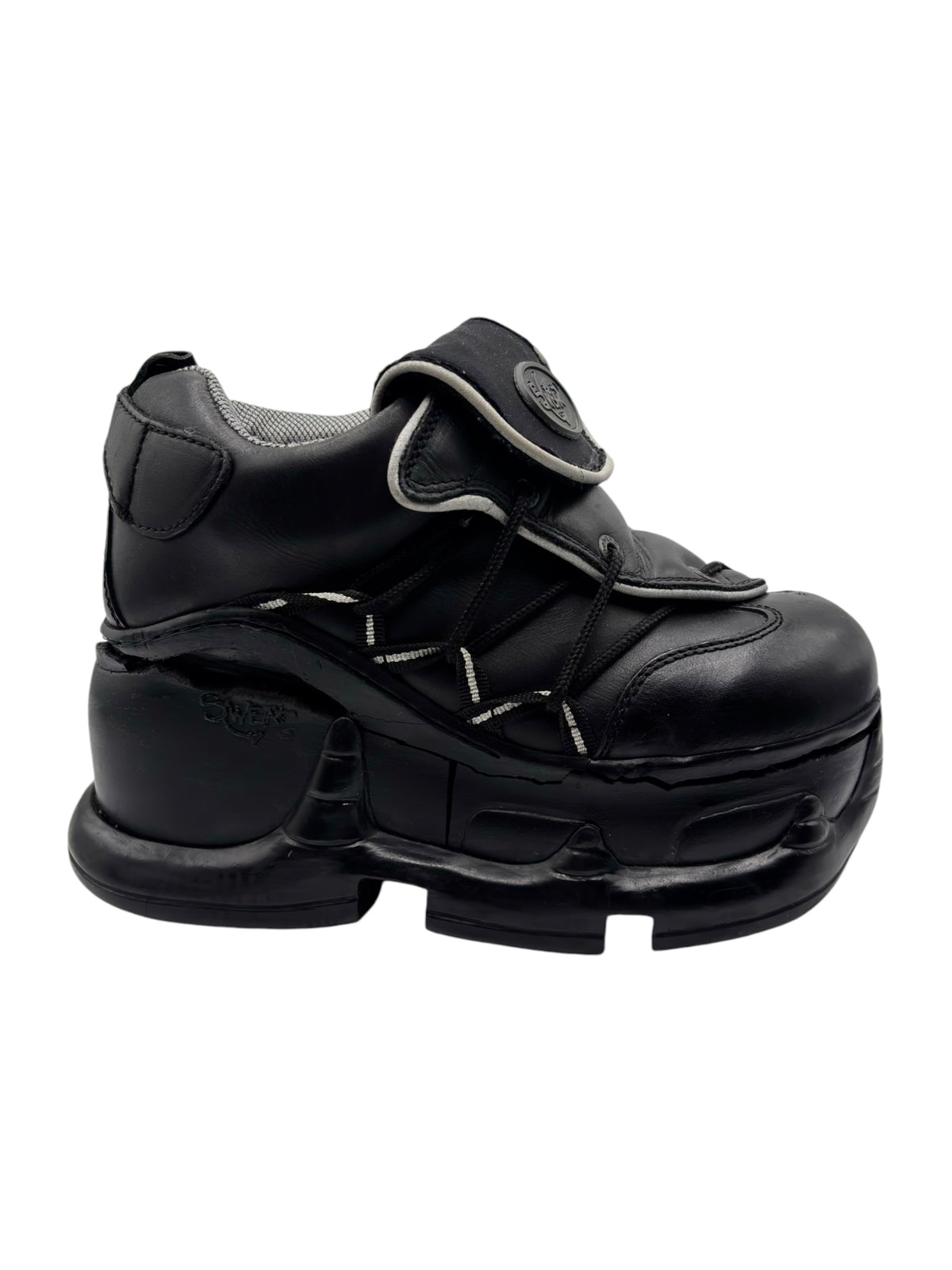Black platform boots with buckle strap and low-profile padded collar.