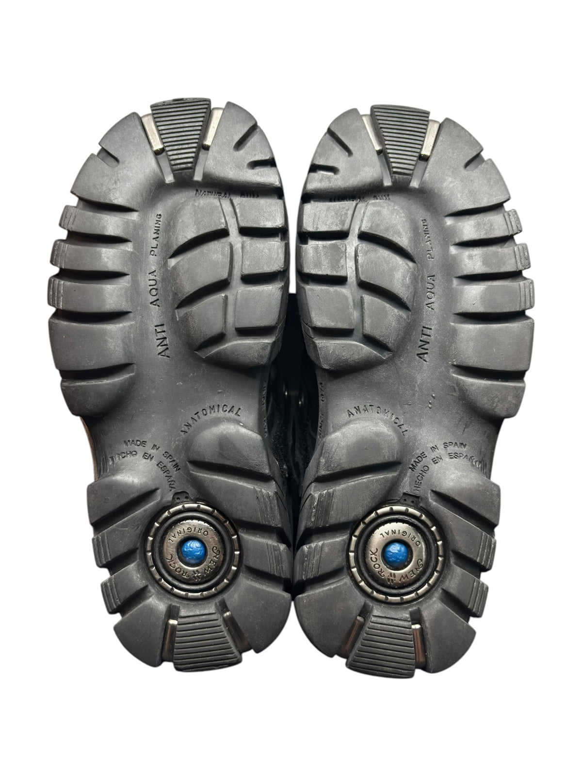 Pair of New Rock platform boots soles showing chunky tread and circular logo inserts