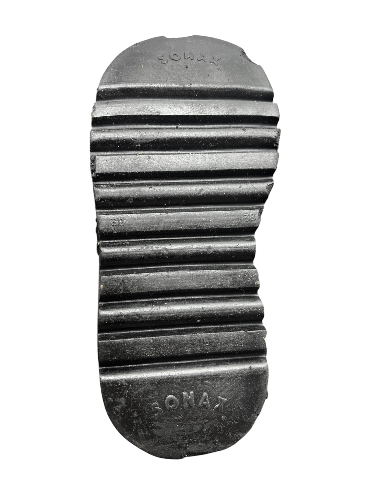Black leather platform boot outsole with ridged traction pattern