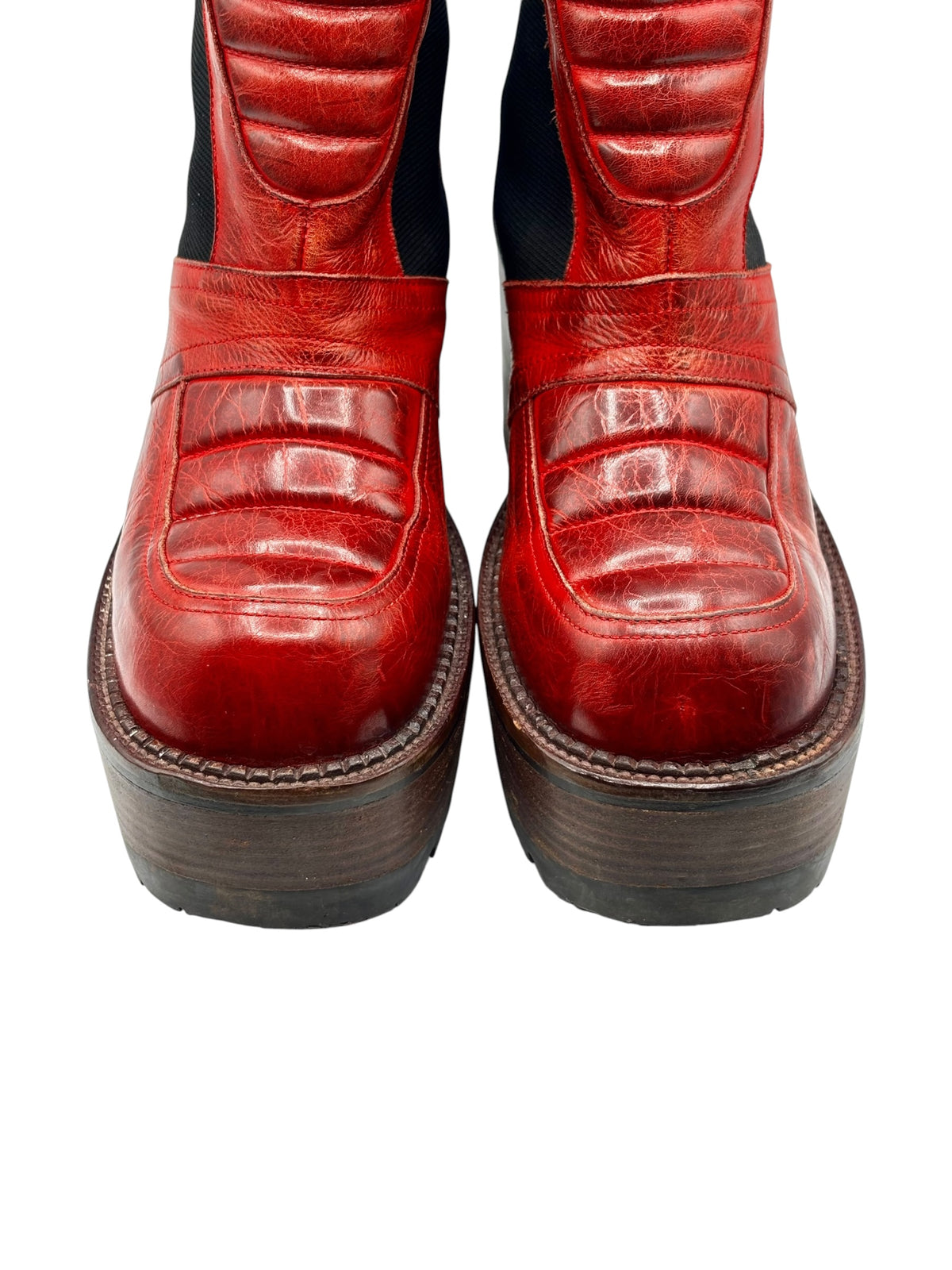 Red leather ankle boots with stitched heel collars and black elastic inserts