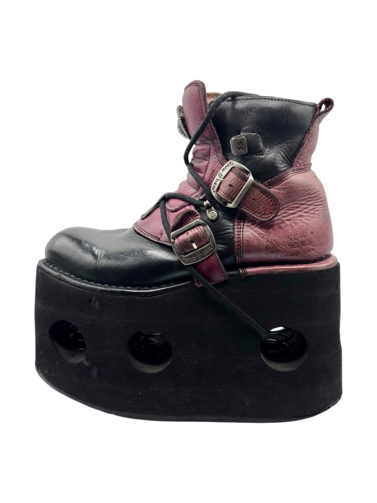 Purple and black platform boots with buckled straps and lace-up front