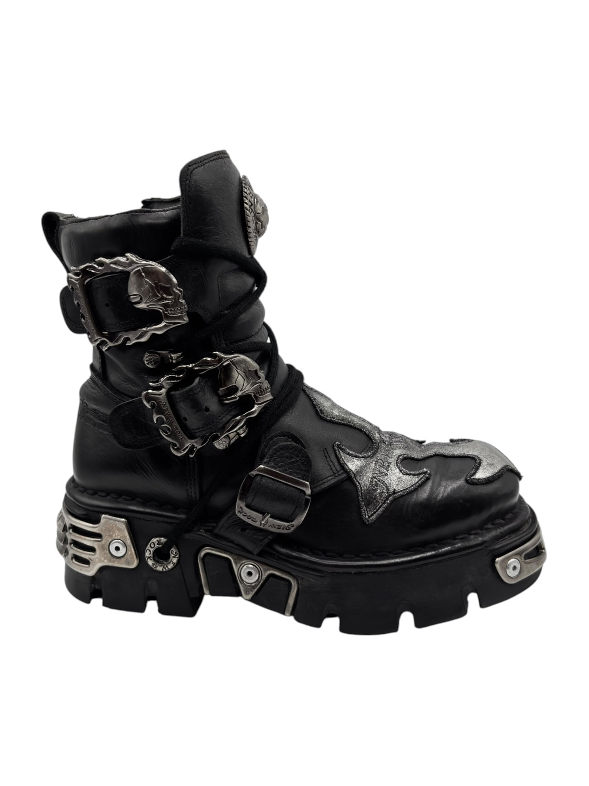 Black platform boots with multiple buckles and chain-like strap accents across the uppers