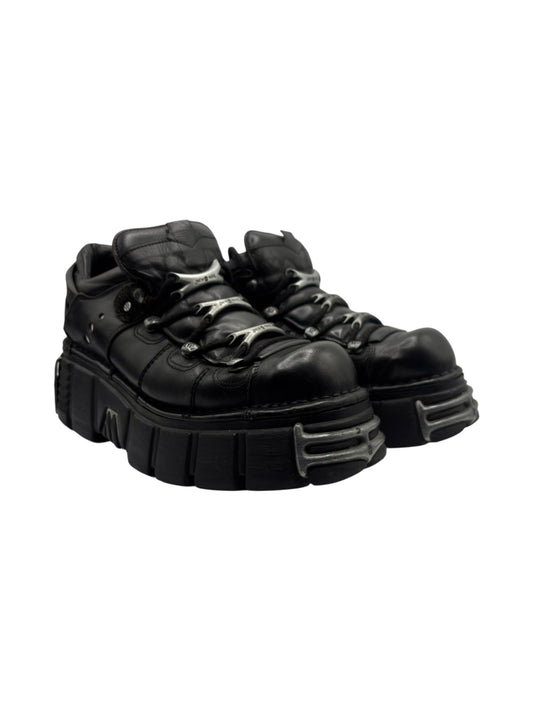 Black platform boots side angle showing chunky midsole and treaded outsole
