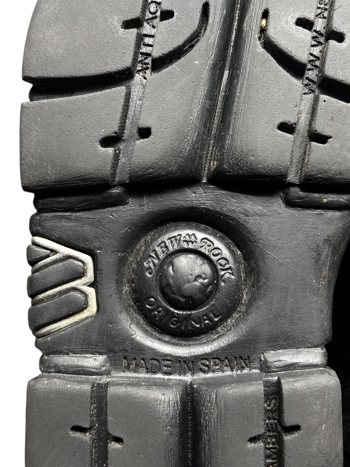 Black platform boot sole with tread and “Made in Spain” logo badge.