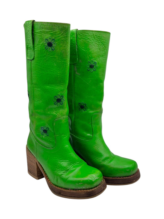 Green knee-high leather boots with side pull tabs and black flower appliques