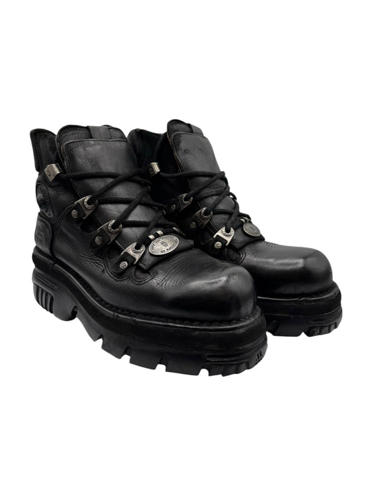 Black lace-up ankle boots with chunky lug sole and metal eyelets