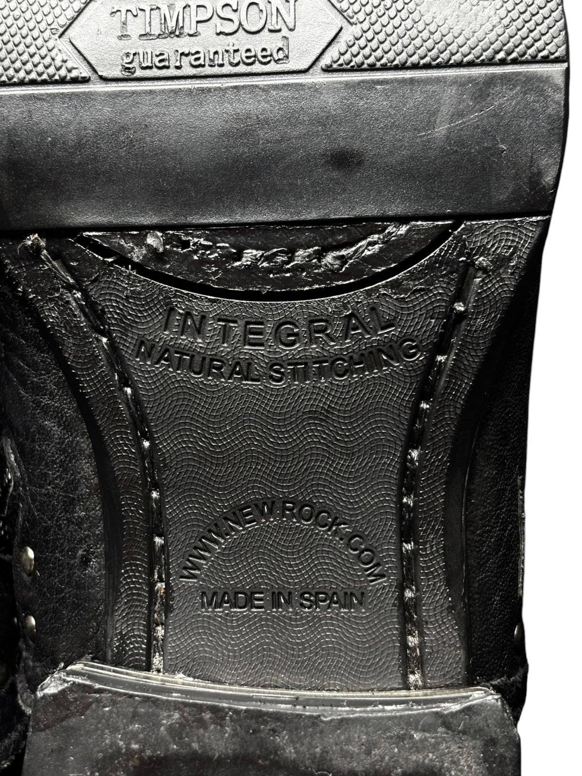 Black boot upper with metal studs and embossed side panel branding detail.