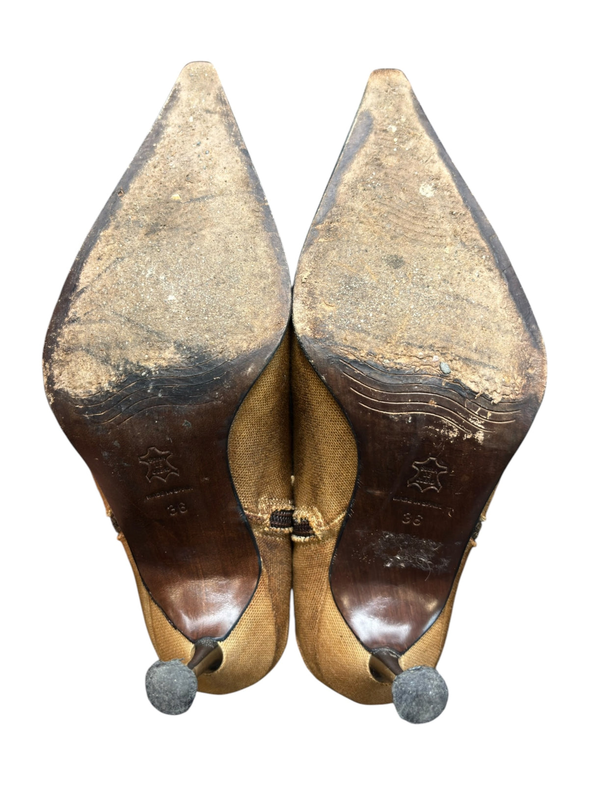 Pair of tan ankle boots with high heels and round decorative heel caps