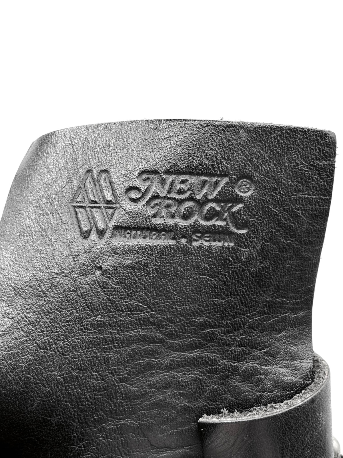 Black boot heel back with embossed logo and worn leather edge