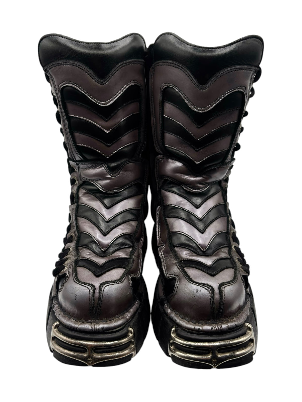 Front view of black platform boots with zigzag stitching, laces, and rugged low heel tread