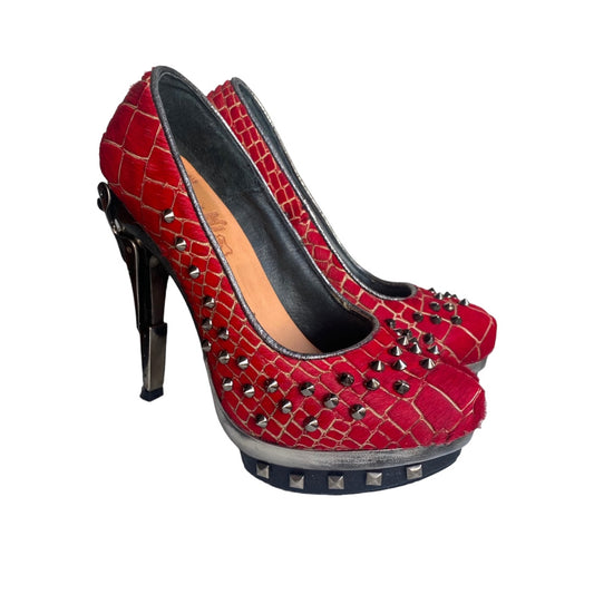 Red crocodile-embossed high-heel pumps with black trim, metal studs, platform sole