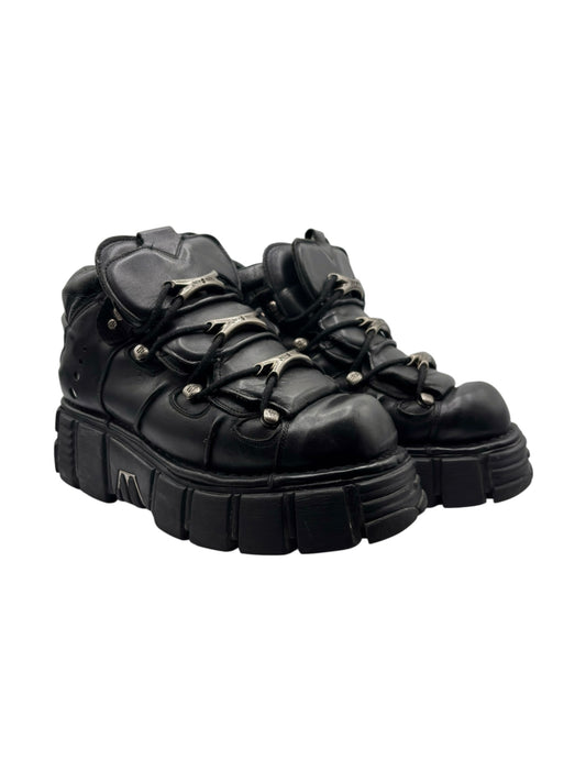 Side-by-side pair of black platform boots with chunky soles and lace-up uppers