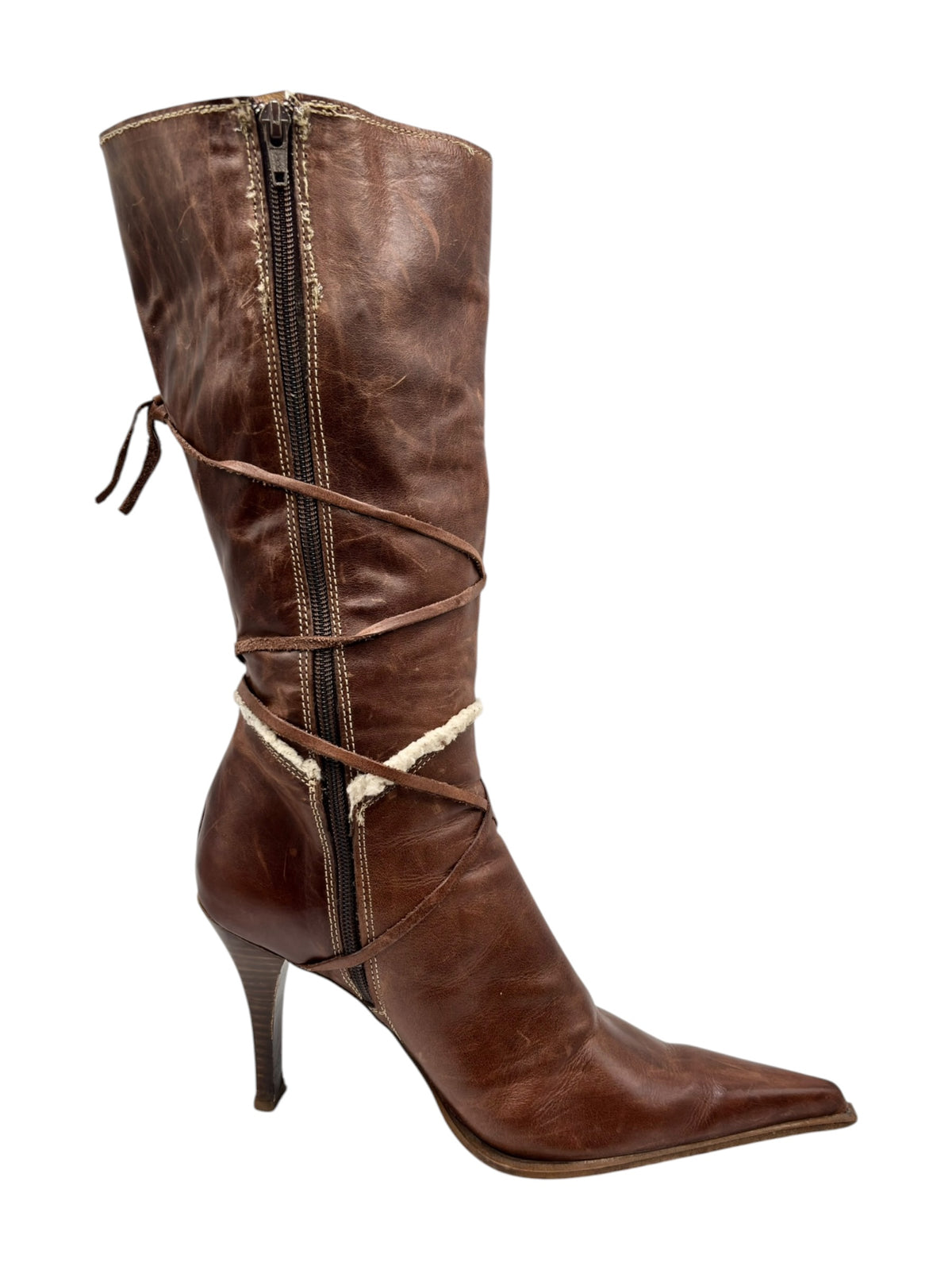 Brown distressed leather boots with pointy toes, side zipper, and laced wrap ties.