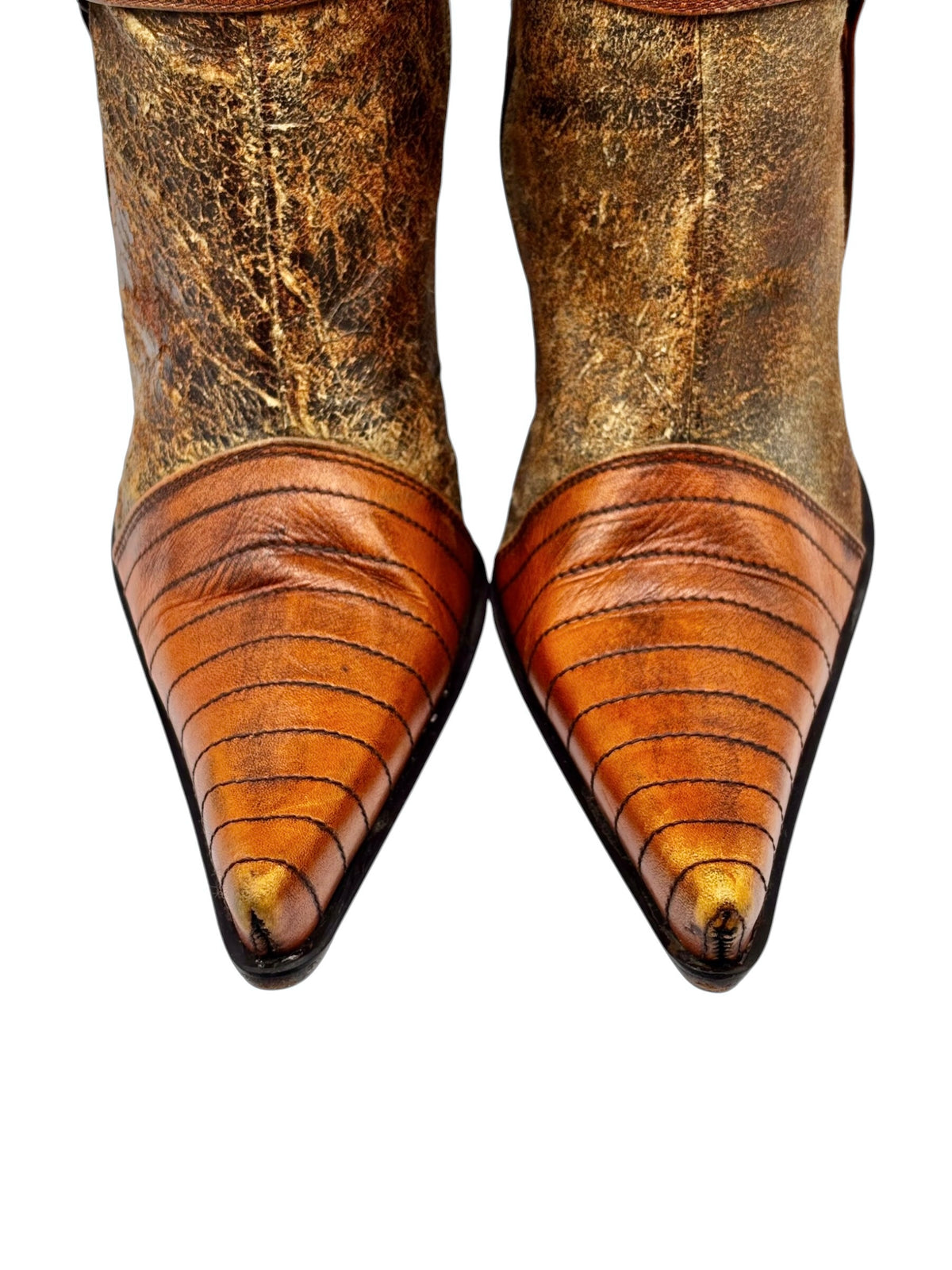 Orange leather pointed-toe heeled boots with textured toe stripes