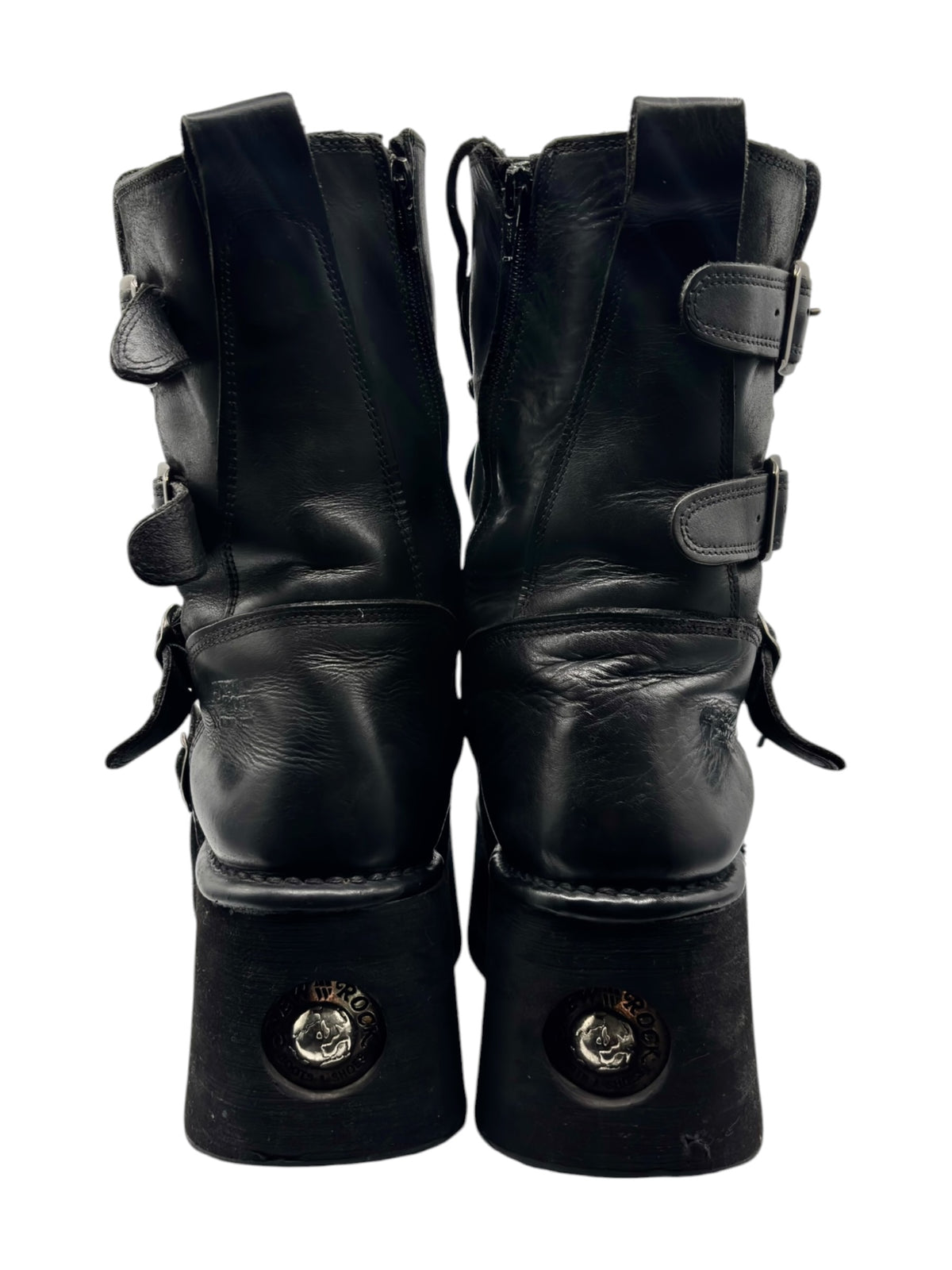 Pair of black mid-calf platform boots with laced uppers and side strap hardware