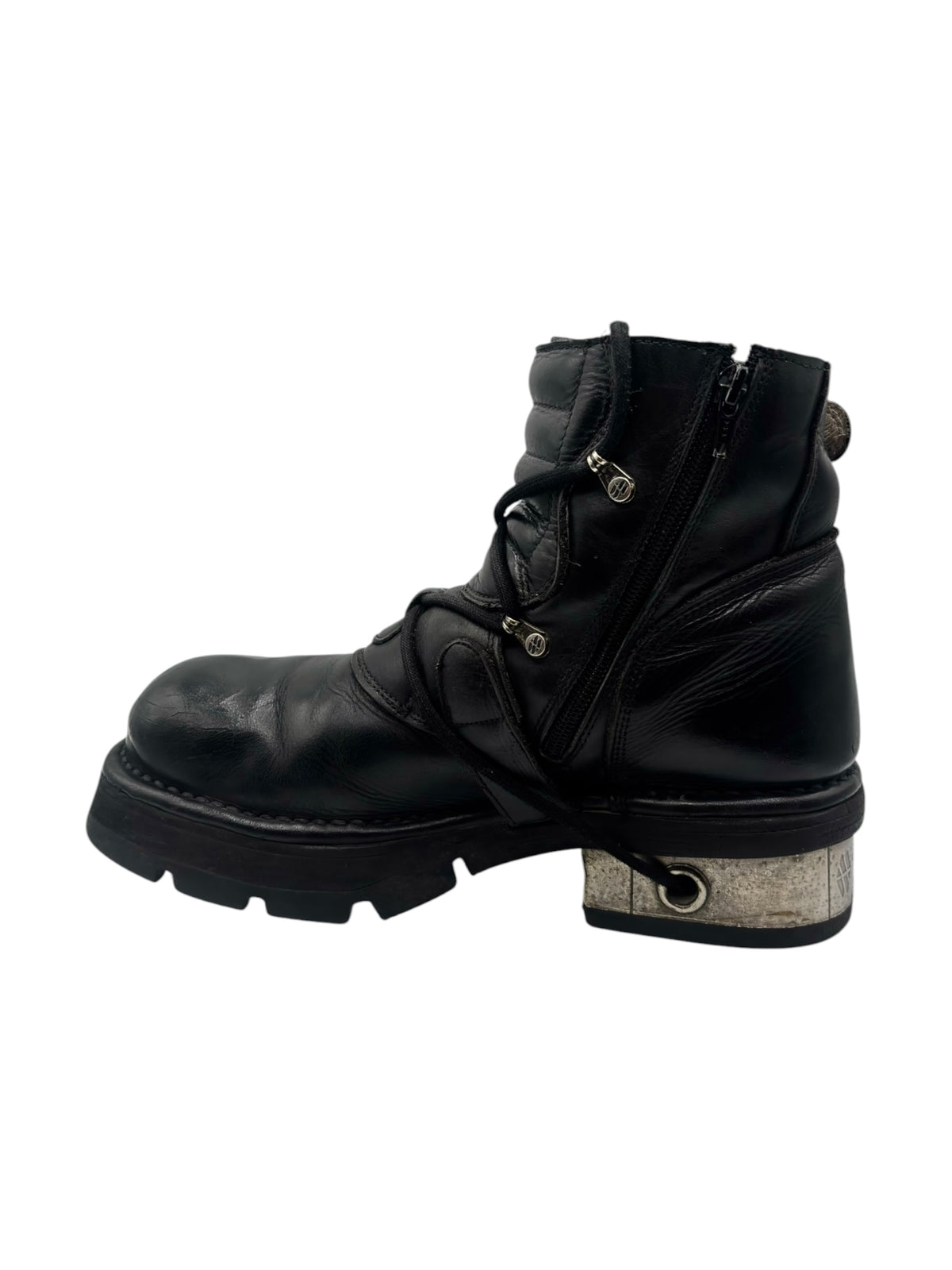Black raised heel ankle boot with front strap buckle and worn textured sole