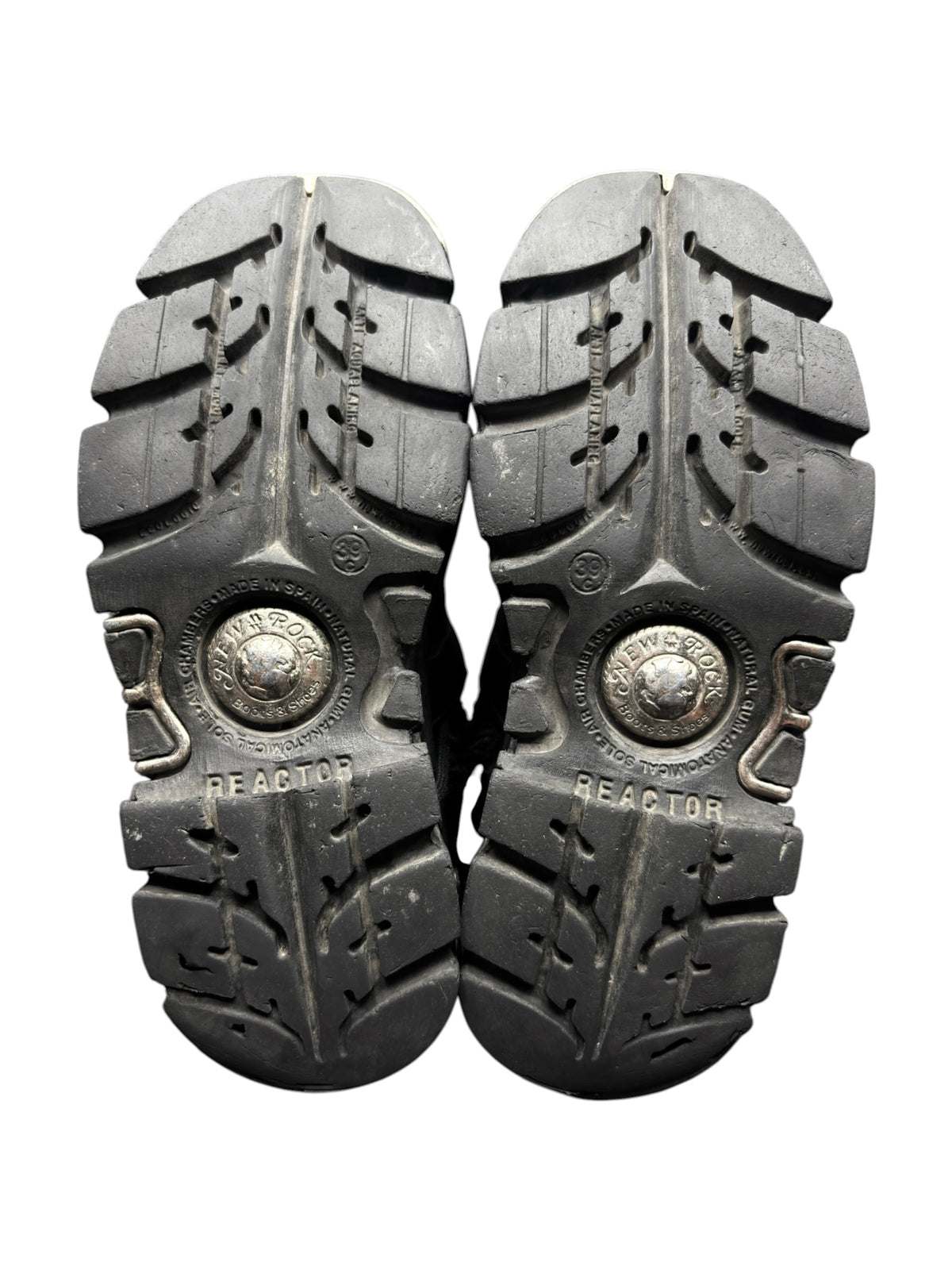 Pair of knee-high boots with chunky black tread soles and “REACTOR” embossed plates