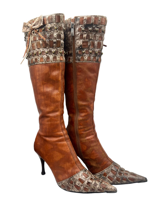 Brown knee-high leather boots with studded toe and side zipper, angled front view.