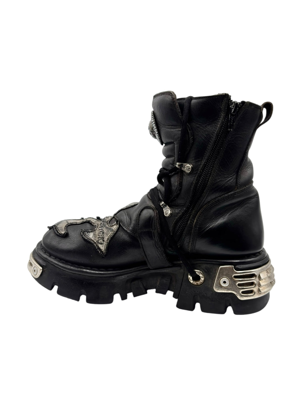 Black mid-calf boots with zipper, wrap straps, and chunky tread platform sole