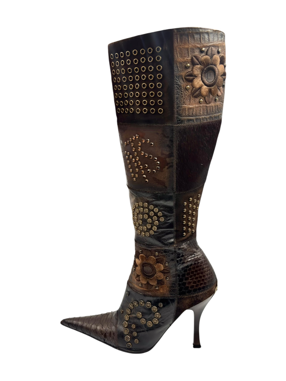 Handcrafted knee-high leather boot with pointed toe, stiletto heel, and floral studded patches