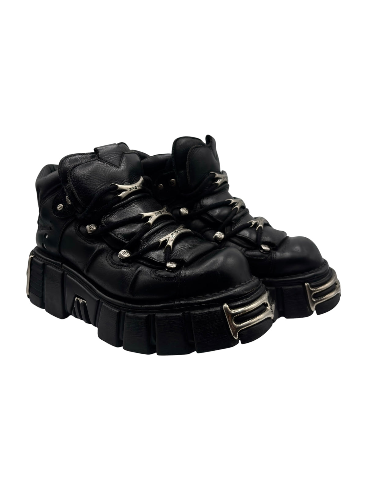 Black lace-up platform boots side view with chunky tread and metal trim
