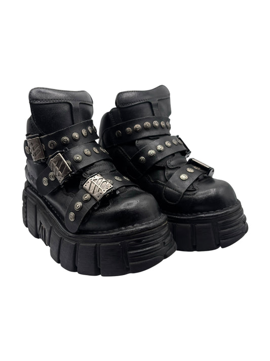 Black studded platform boots with side buckles and chunky lug sole