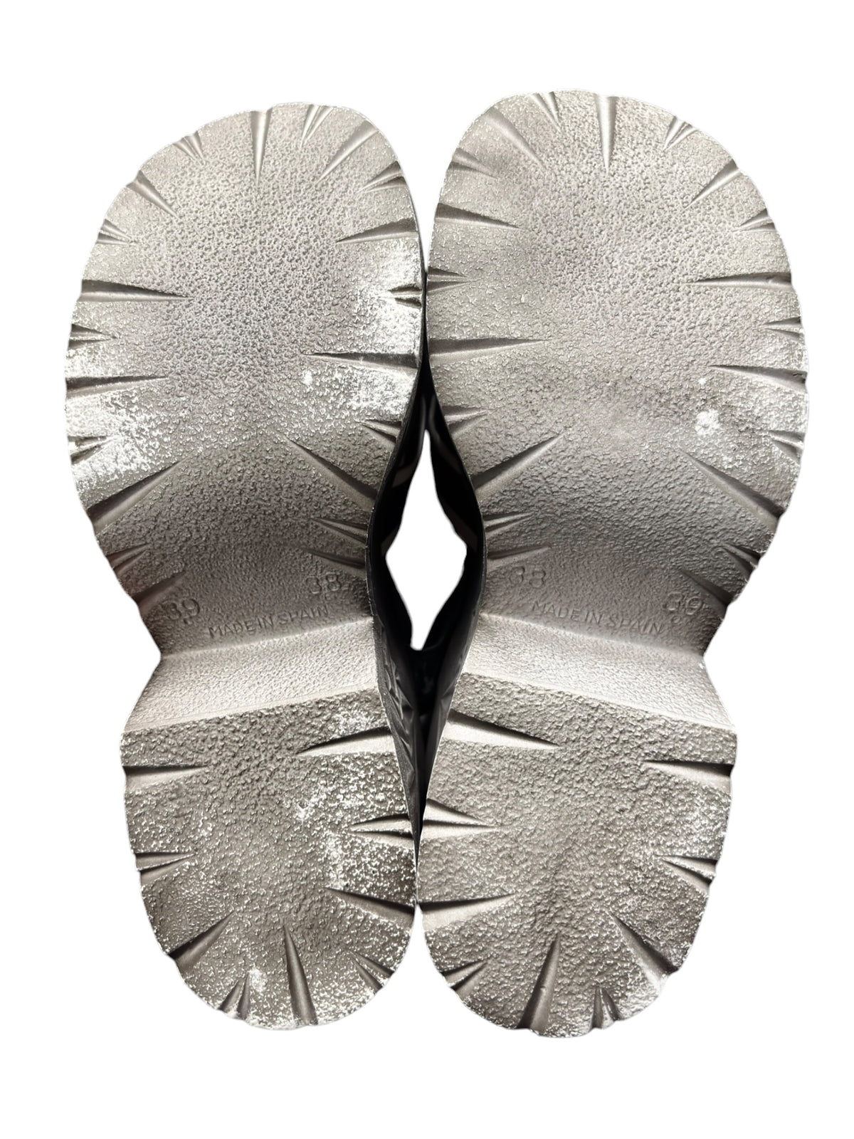 Two sandal outsoles with starburst tread and embossed grip pattern