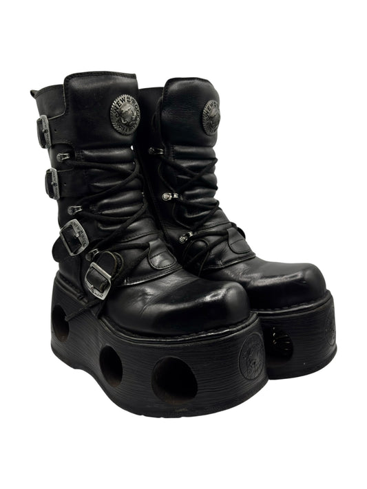 Black leather platform boots angled view with lace-up front and buckle straps