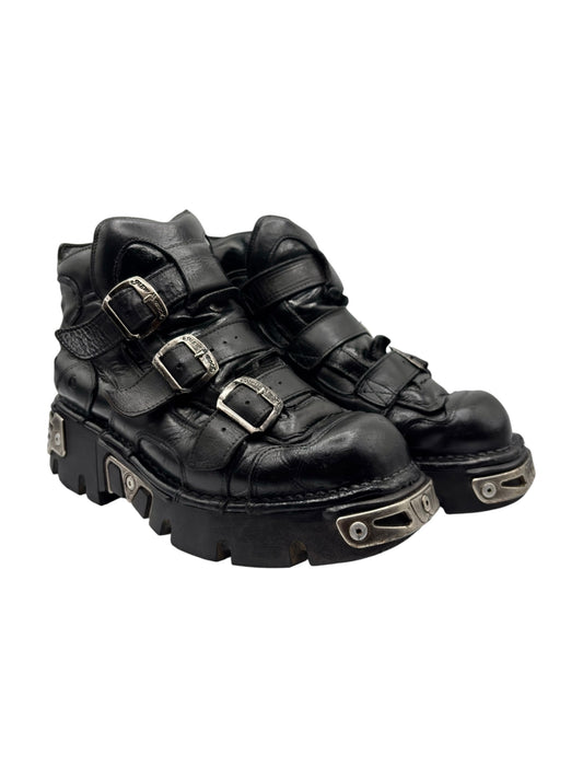 Black buckle platform boots, side view with silver-tone buckles and treaded sole