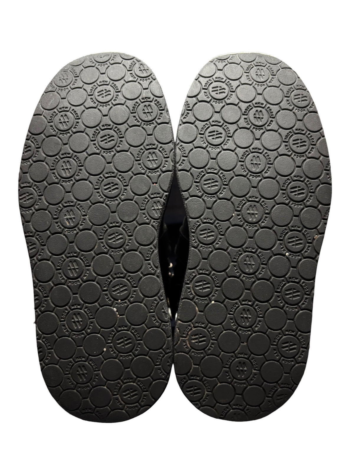 Pair of black platform boot outsoles with circular tread pattern
