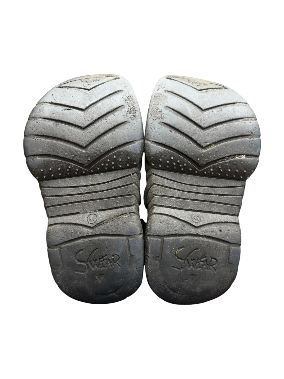 Pair of light platform shoes with dark chevron outsole tread and Swear logo on heel