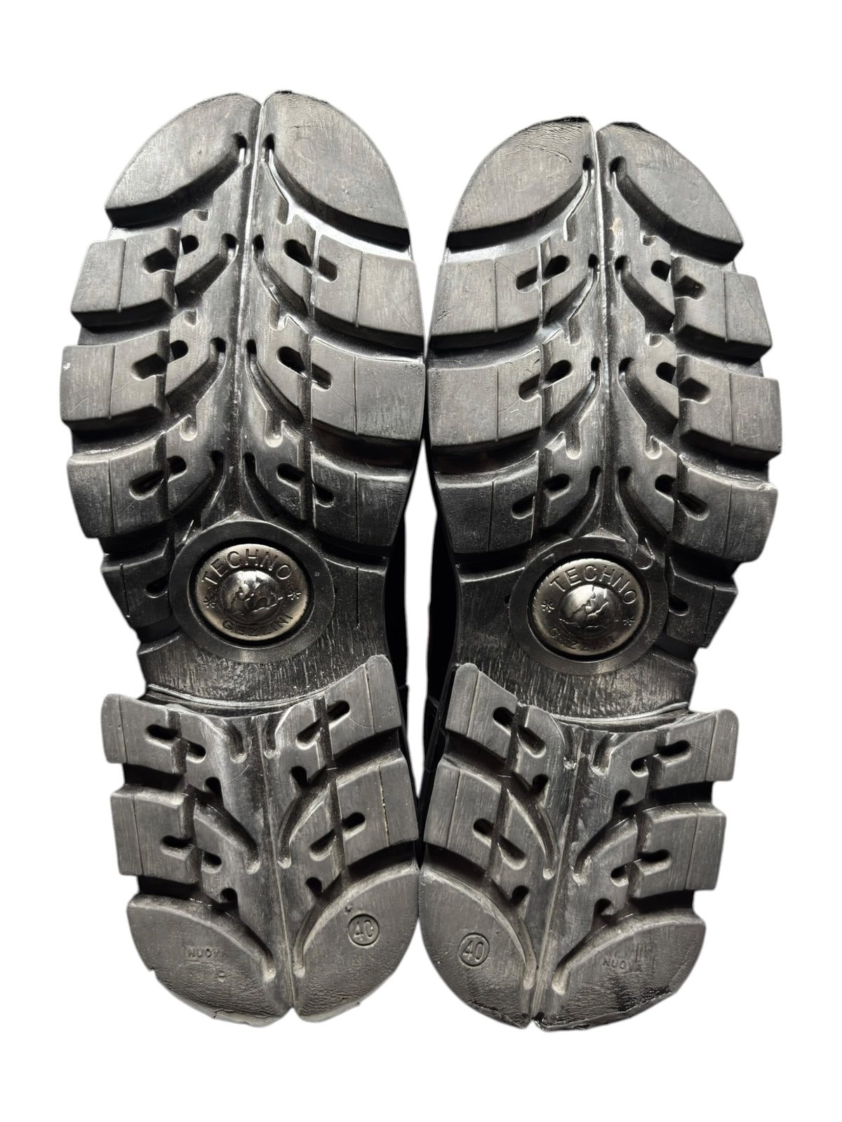 Pair of platform ankle boots shown from the outsole with deep lug tread