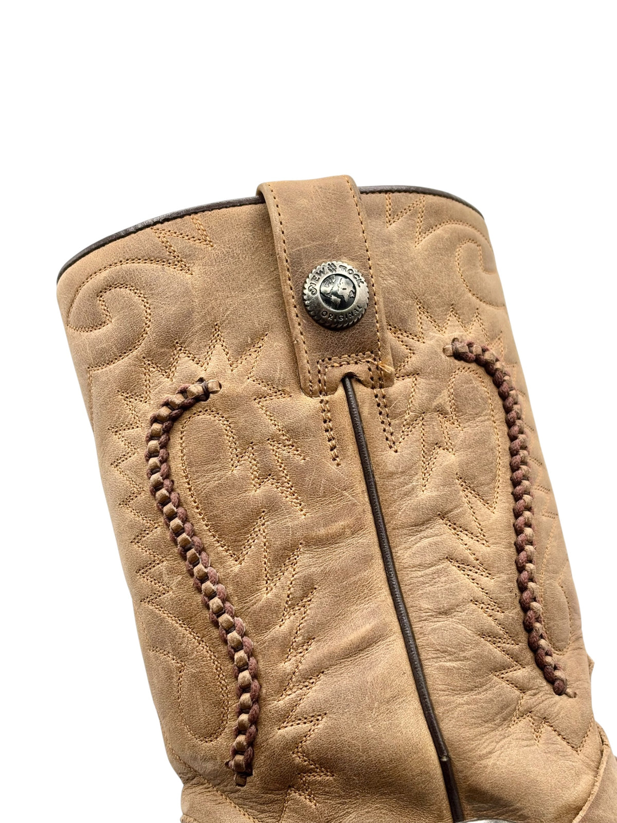 Beige boot shaft with embossed pattern, side zipper, and stitched panel edges