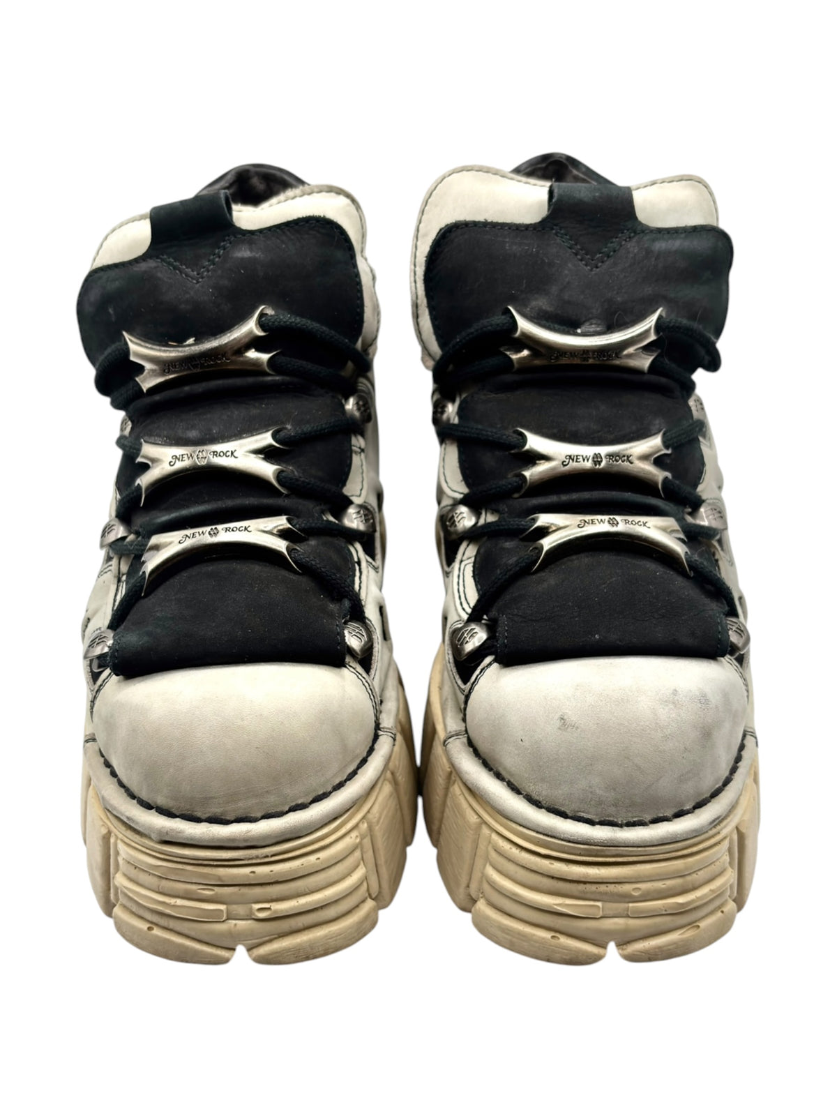 Side view of beige and black platform boots with crinkled uppers and stacked sole