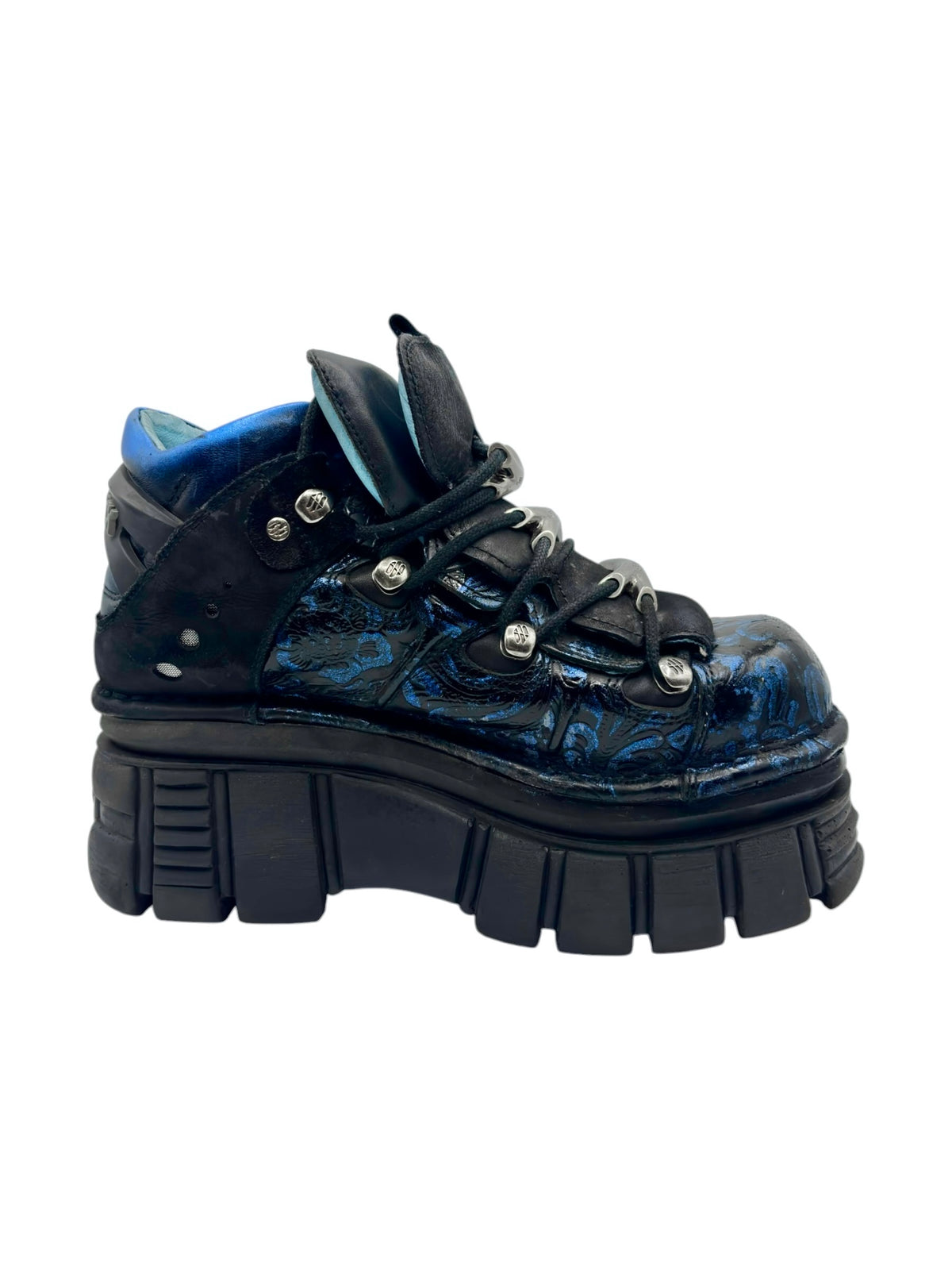 Side view of blue patterned platform boots with black lace-up and raised sole
