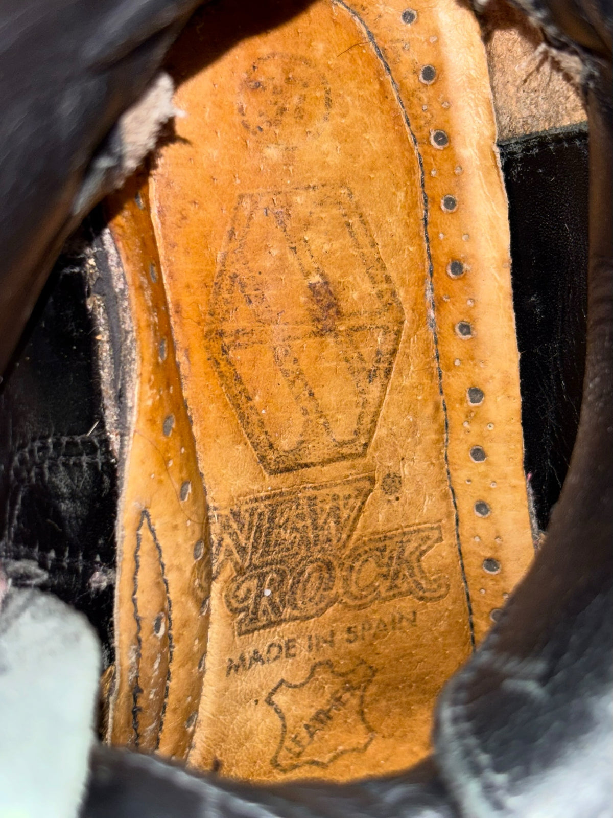 Boot interior view with tan lining, stitched panels, and eyelet lace area