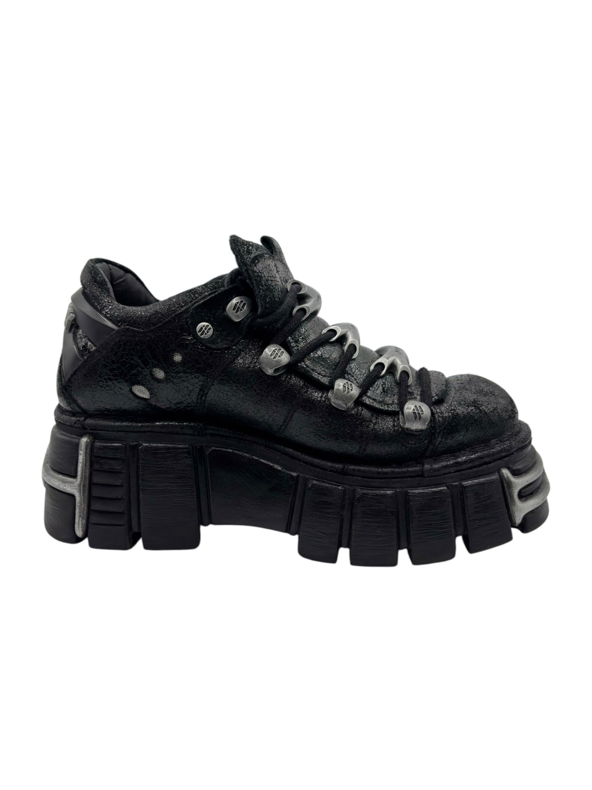 Black platform boots side view with lace eyelets and chunky molded outsole