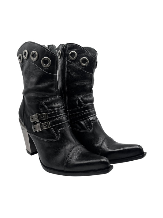 Black leather mid-calf witch heels with eyelet rings, center buckle, and block heel