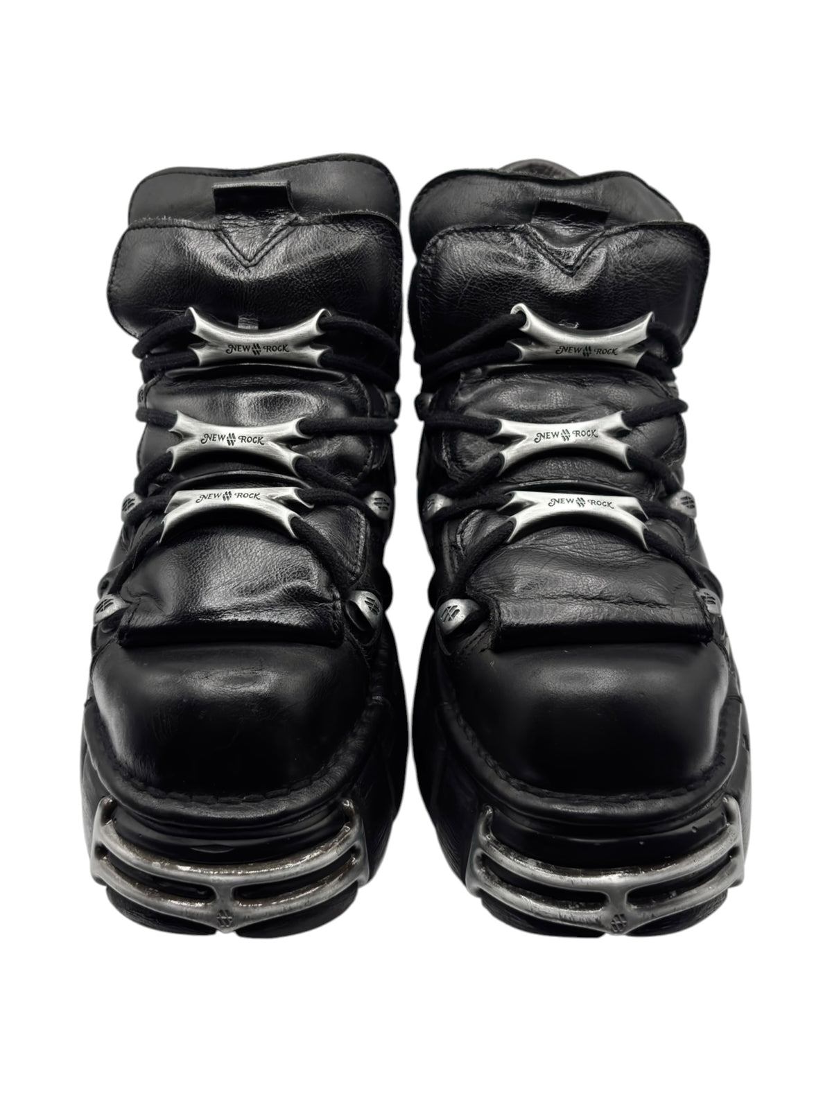 Black leather platform boots with rear strap and stacked sole tread detail.
