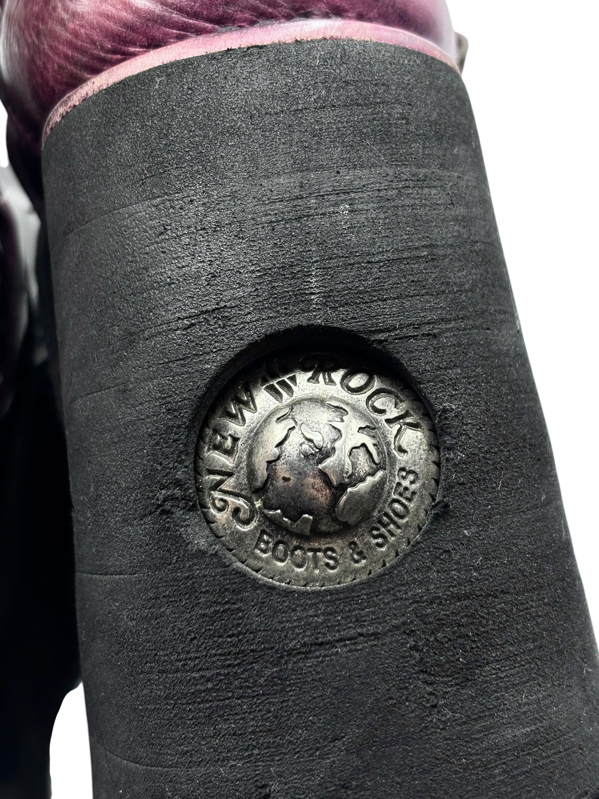Black platform boot heel with circular New Rock logo emblem