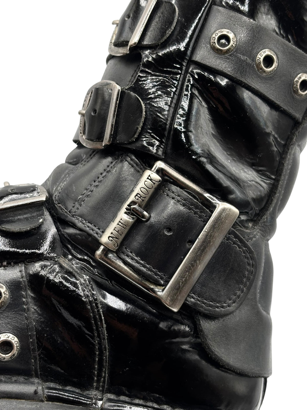 Vintage black leather boot with triple metal buckles and stitched strap details