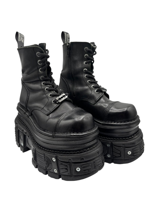 Pair of black platform ankle boots, angled view, lace-up design and chunky studded sole